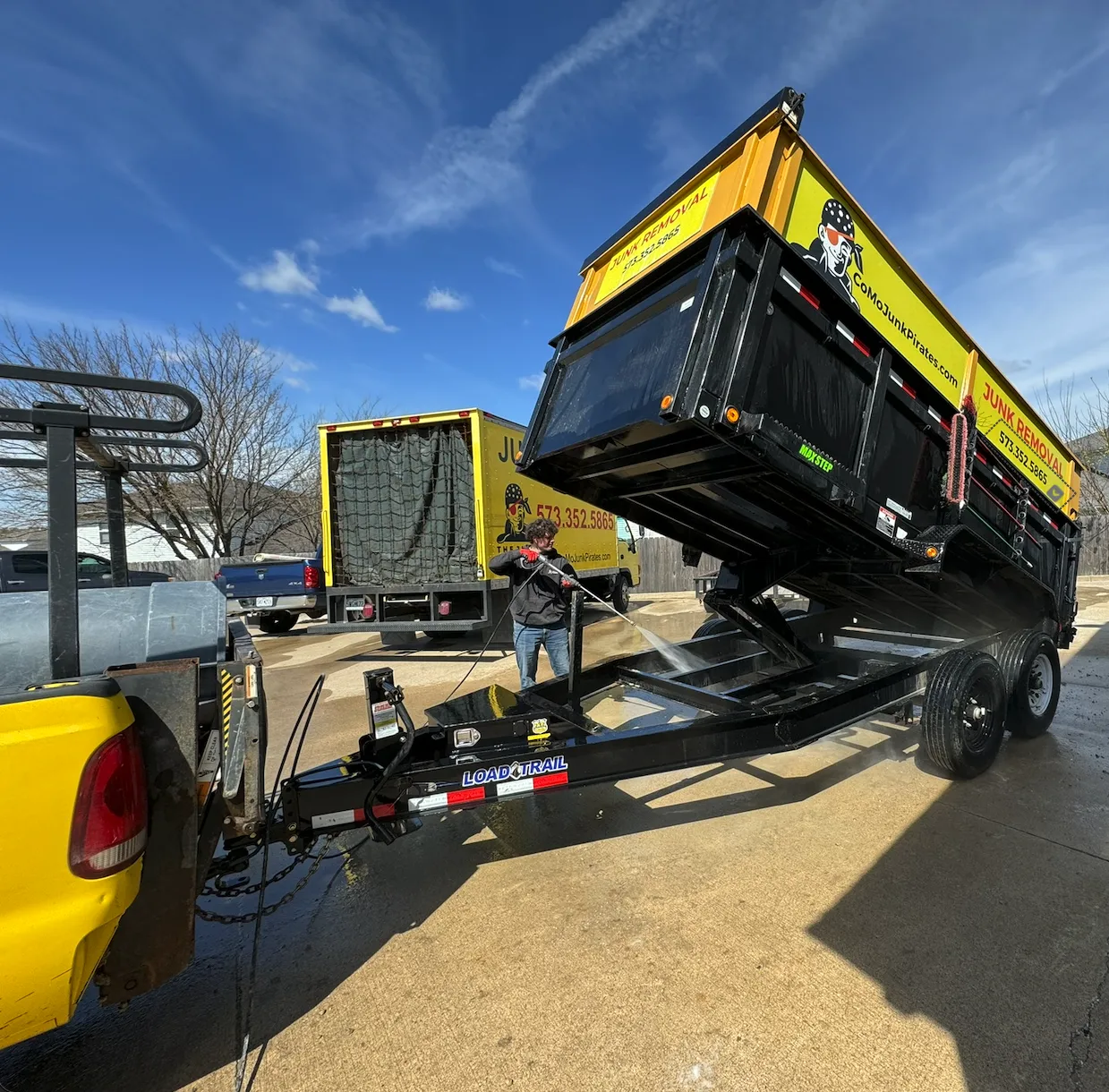A Junk Pirates dump trailer fully tipped and unloading a finished job back at the yard, ready for the next pickup.